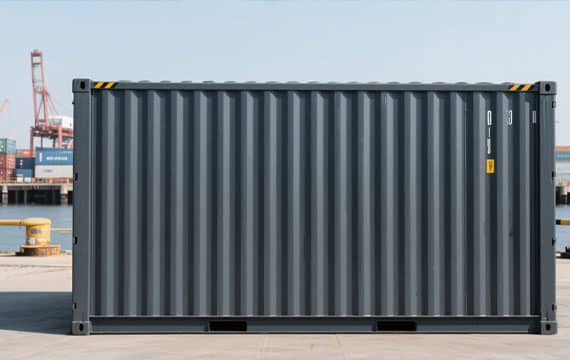 Worker applying zinc-rich primer to a steel shipping container during manufacturing