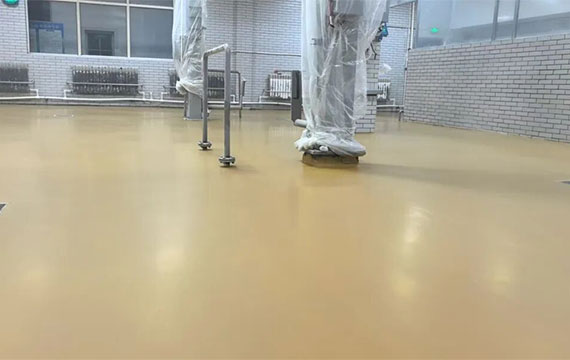 Durable and slip-resistant JINYU MF polyurethane flooring in a high-traffic, wet processing area. Its smooth yet textured finish ensures safety and withstands heavy use.