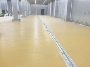 Close-up view of polyurethane mortar flooring surface showing seamless finish and anti-slip texture, ideal for food processing areas with wet conditions