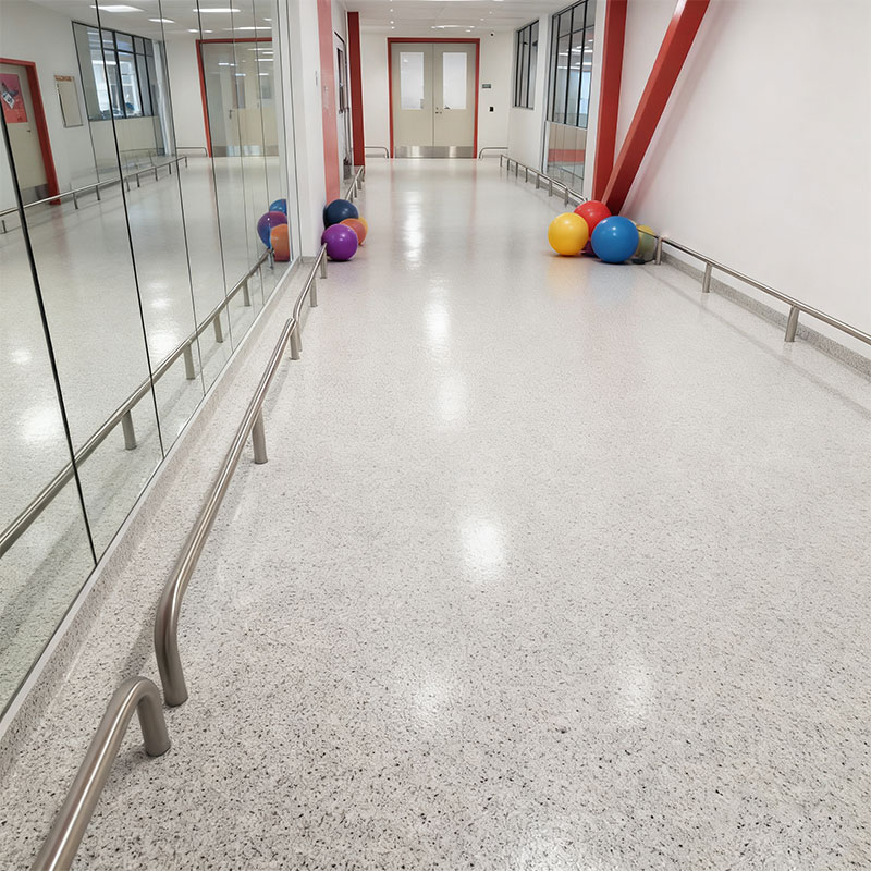 FortiFlex Deco Flake SB decorative flake flooring in a modern gym, showcasing a durable and slip-resistant surface under heavy equipment and high foot traffic.