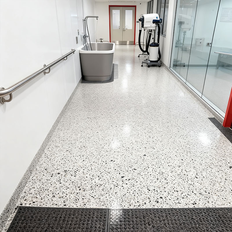 Seamless and sanitary FortiFlex Deco Flake SB polyaspartic flooring in a healthcare setting, showcasing a hygienic, easy-to-clean decorative flake surface that resists chemicals and bacteria.