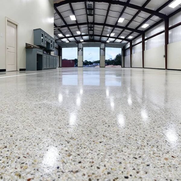 Professional gray epoxy garage floor coating with decorative multi-color flakes, finished with aliphatic urethane topcoat for high-gloss chemical resistance.