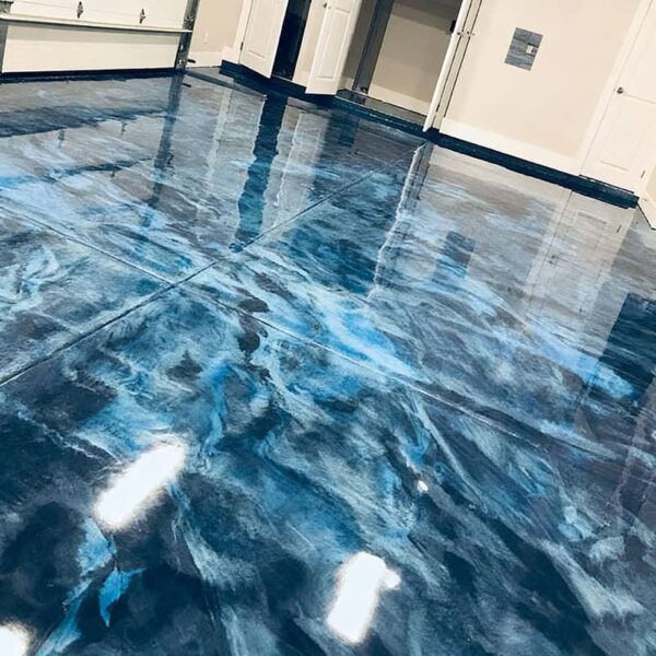 Professional metallic epoxy floor with stunning 3D marble effect in a residential garage, showing custom color blending and high-gloss finish.