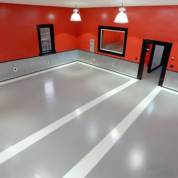 High-gloss solid black epoxy resin garage floor, demonstrating the smooth, durable finish achieved with a DIY 100% solids epoxy kit.