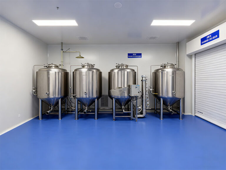 A pharmaceutical cleanroom featuring blue seamless polyurethane (PU) flooring, stainless steel tanks, and cleanroom infrastructure, designed for sterile pharmaceutical manufacturing