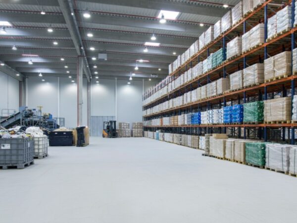 A clean, expansive warehouse floor featuring ResuShield Screed M46, a high-impact epoxy mortar flooring system designed for industrial environments and heavy-duty loading docks.