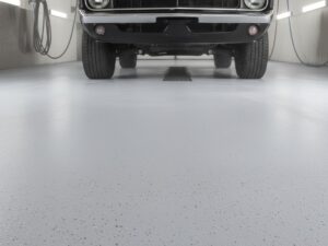 KAIDA PAINT high-strength grey seamless epoxy flooring system in a professional car wash bay, providing slip resistance and chemical protection under a classic vehicle.