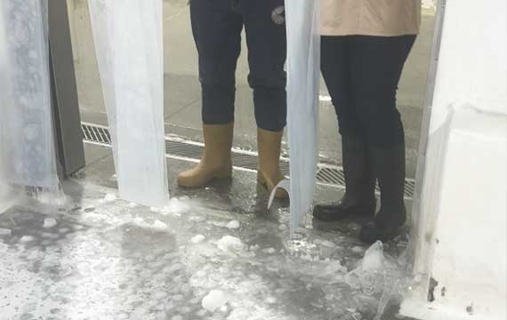 Cold room challenge: Severe ice accumulation on the industrial floor near the loading dock, creating extreme slip hazards and substrate stress.