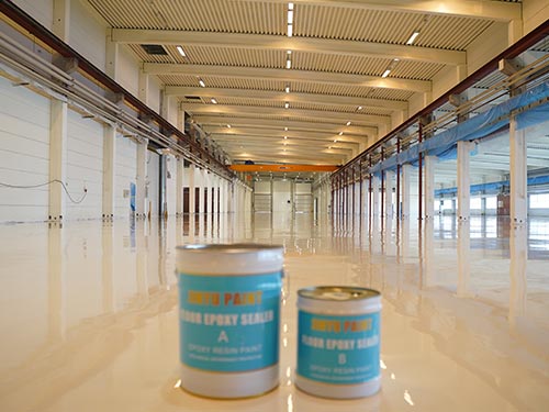 KAIDA Paint floor epoxy sealer cans displayed on the newly finished, seamless high-performance industrial floor in Sweden.