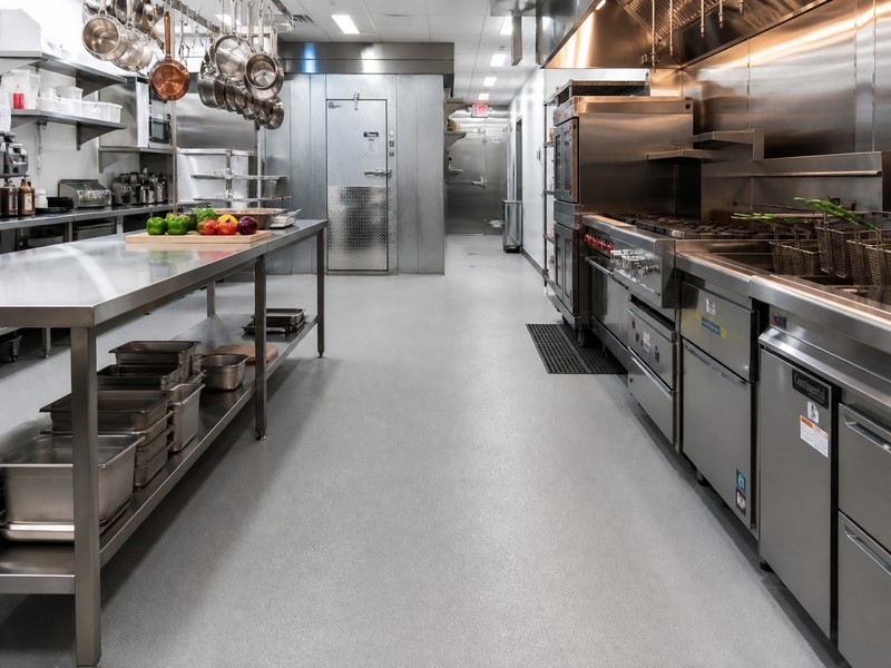 Seamless urethane cement commercial kitchen flooring with anti-slip texture and thermal shock resistance.
